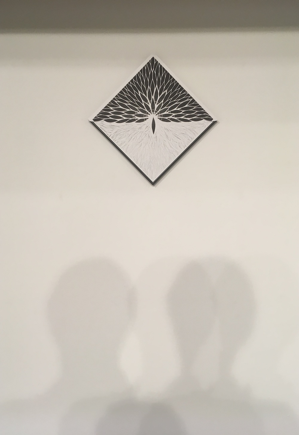 A black and white diamond of mysterious shapes